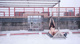 A naked woman sitting on top of a metal structure.