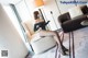 A woman sitting on a chair in a living room.