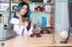 A woman sitting at a desk talking on a telephone.