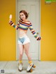 A woman on roller skates holding an ice cream cone.